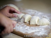 Slice piece of dough into equal size smaller pieces (depending on the size of pies you want to get make these pieces bigger or smaller)
